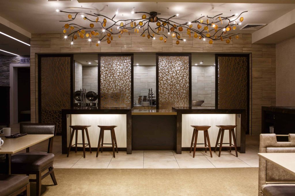 A series of large sliding wall panels feature a stunning cross-hatched pattern within this hotel dining space.