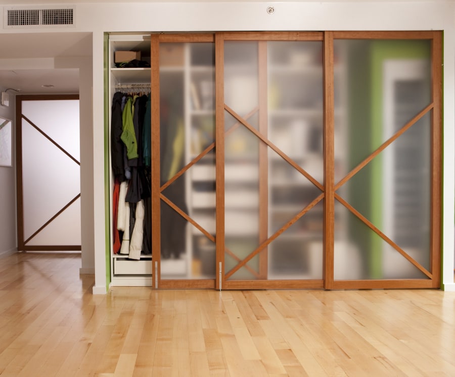 A Raydoor sliding wall enclosing a closet.