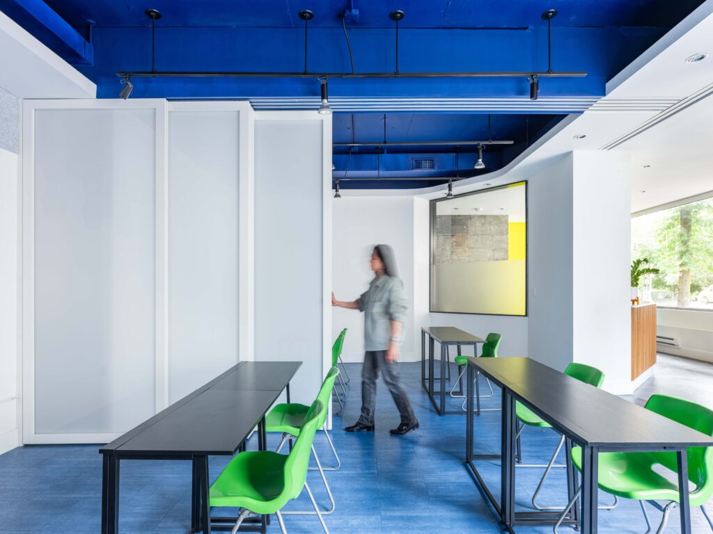 Person opening classroom partitions at Robofun