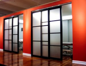 Trackless Raydoor sliding system with concealed hardware to help with cleanliness and infection control in healthcare setting